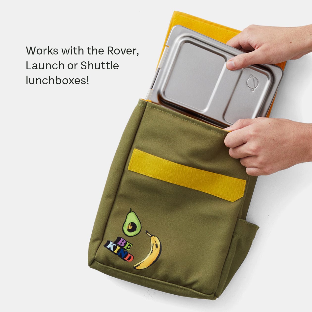 Stainless steel lunchbox being placed in Green lunch sack.