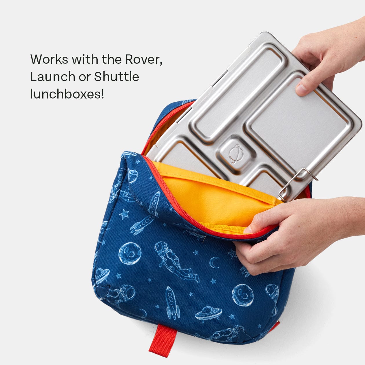 Hands putting Rover lunchbox into the Space Bag. Text says Works with the Rover, Launch or Shuttle lunchboxes!