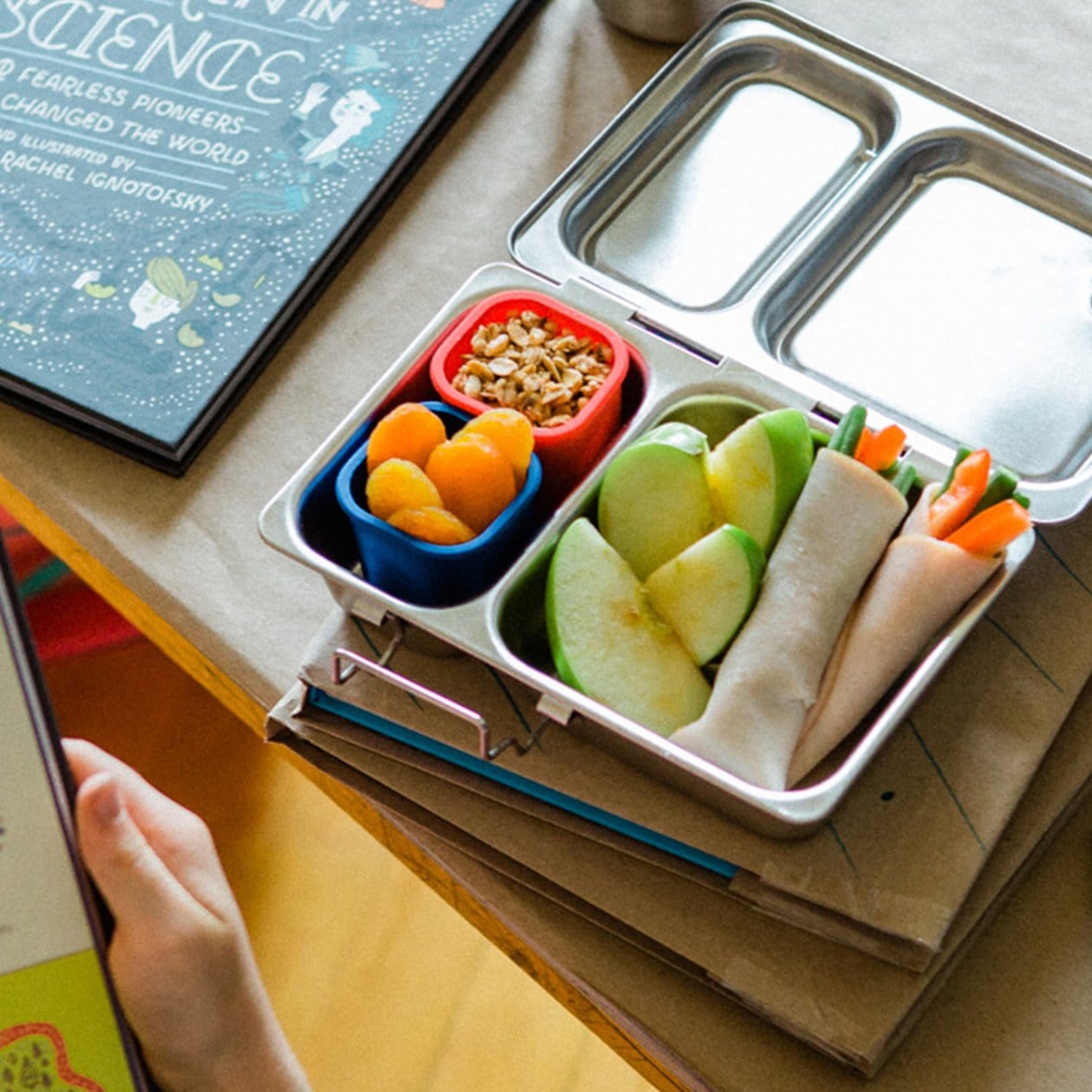 PlanetBox Shuttle lunchbox, with pods inside filled with snacks. 