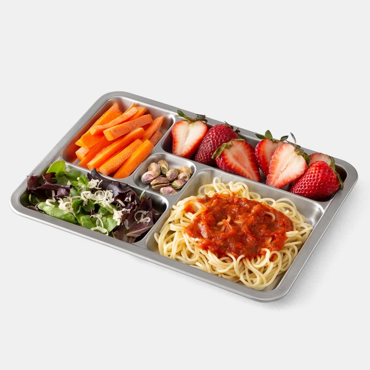 3/4 view of plated Rover Tray. Features strawberries, carrot sticks, small salad, pasta with red sauce, and pistachios.